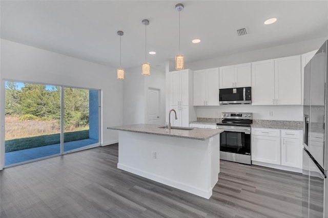 kitchen featuring stainless steel appliances, sink, a center island with sink, white cabinets, and hanging light fixtures