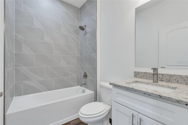 full bathroom featuring toilet, vanity, hardwood / wood-style floors, and tiled shower / bath