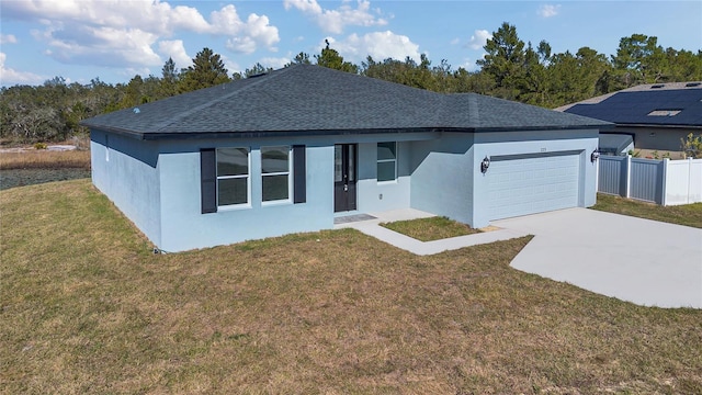 view of front of property featuring a garage and a front yard