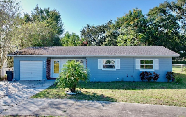 ranch-style house featuring a garage and a front yard