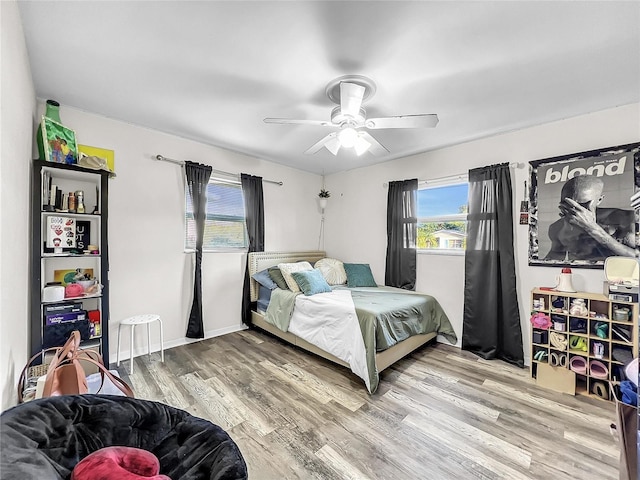 bedroom with hardwood / wood-style floors and ceiling fan