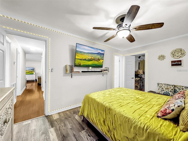 bedroom featuring ornamental molding, dark hardwood / wood-style floors, and ceiling fan