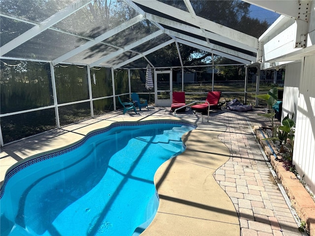 view of pool with a patio and glass enclosure