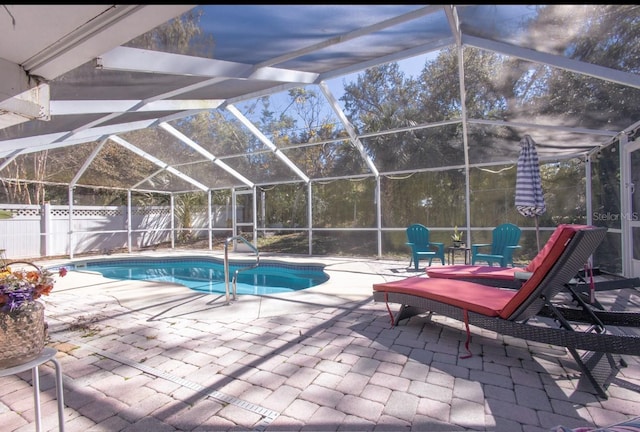 view of swimming pool with glass enclosure and a patio