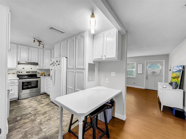 kitchen with stainless steel range with electric stovetop, backsplash, white fridge with ice dispenser, hardwood / wood-style floors, and white cabinets