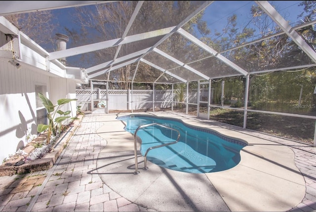 view of pool with a patio and glass enclosure