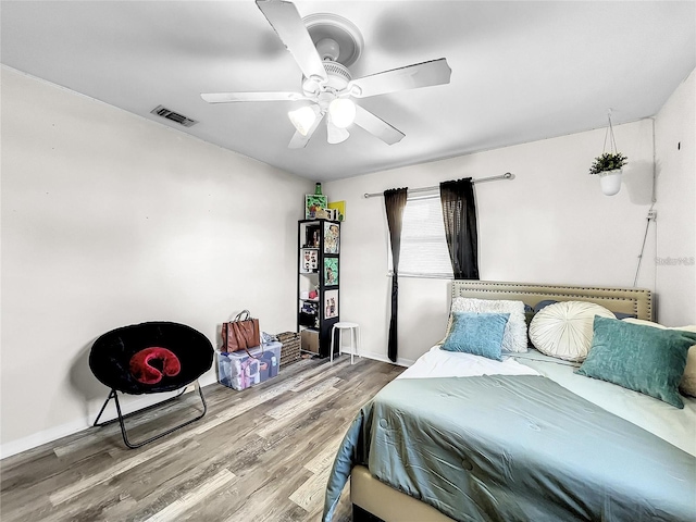 bedroom with hardwood / wood-style floors and ceiling fan