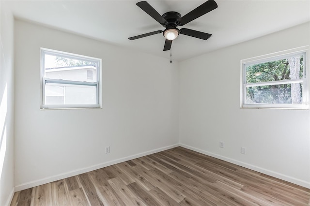 empty room featuring ceiling fan and light hardwood / wood-style flooring