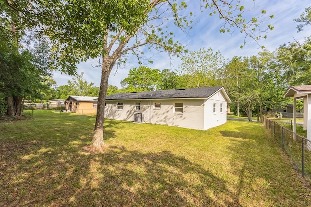 rear view of property with a lawn