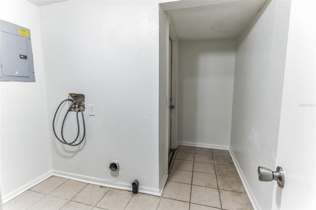 washroom featuring washer hookup, electric panel, and light tile patterned floors