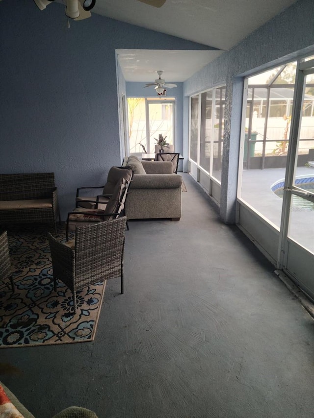 sunroom / solarium featuring ceiling fan and vaulted ceiling