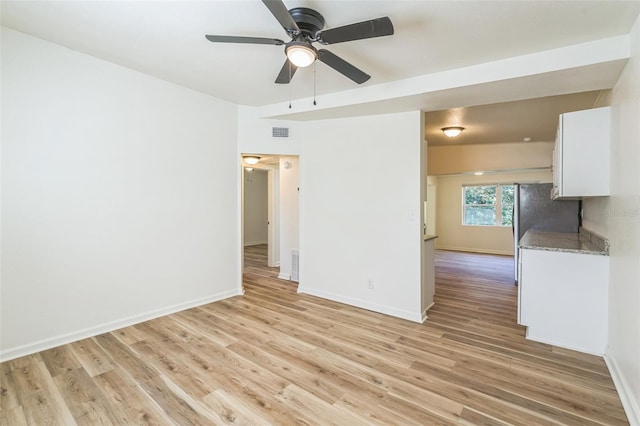 unfurnished room featuring ceiling fan and light wood-type flooring