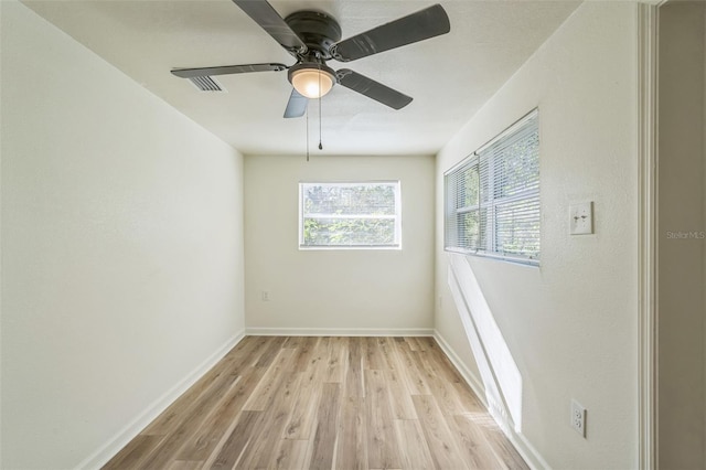 spare room featuring light wood-type flooring and ceiling fan