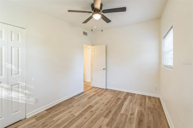 empty room with light wood-type flooring and ceiling fan