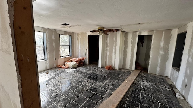 unfurnished room with a textured ceiling