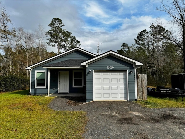 single story home featuring a garage and a front lawn