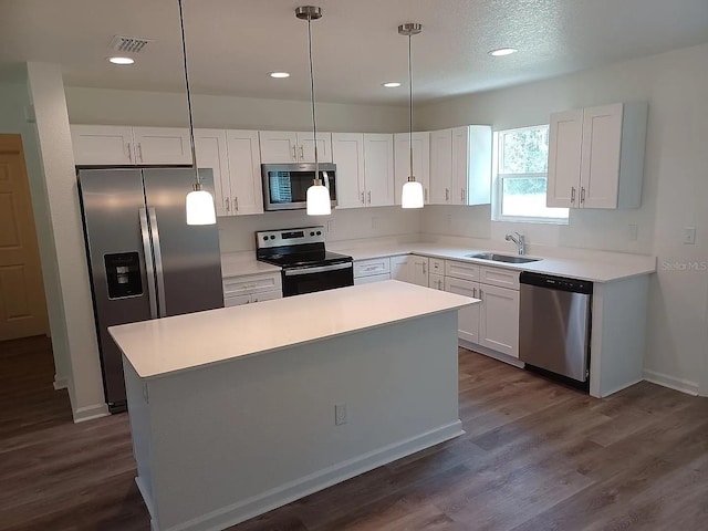 kitchen featuring white cabinets, stainless steel appliances, and a kitchen island