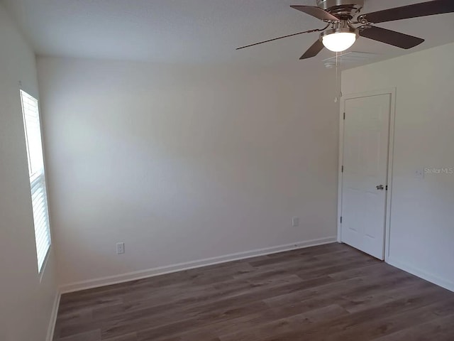 unfurnished room featuring ceiling fan and dark hardwood / wood-style flooring