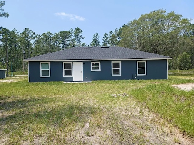 rear view of house with a lawn