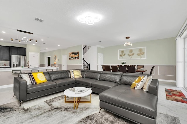 living room featuring sink and a textured ceiling