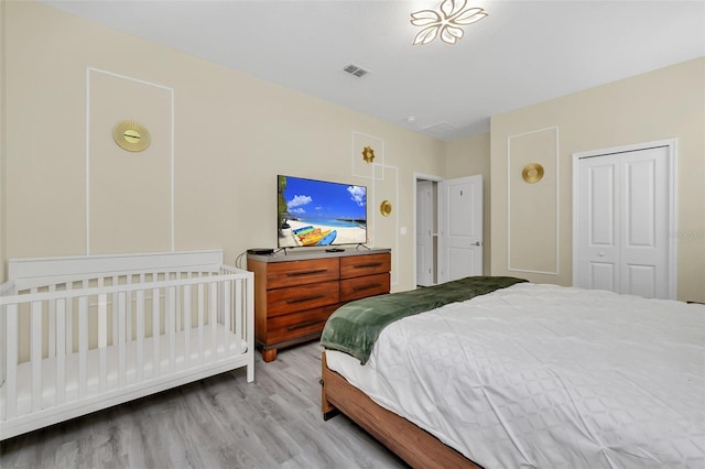 bedroom featuring a closet and light hardwood / wood-style flooring