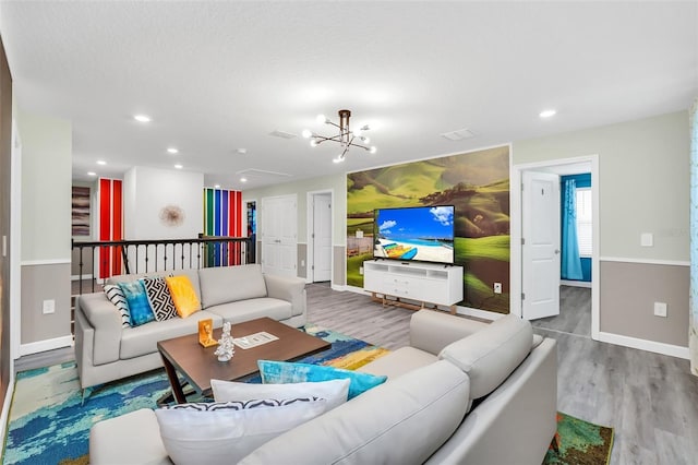 living room with hardwood / wood-style floors and a notable chandelier