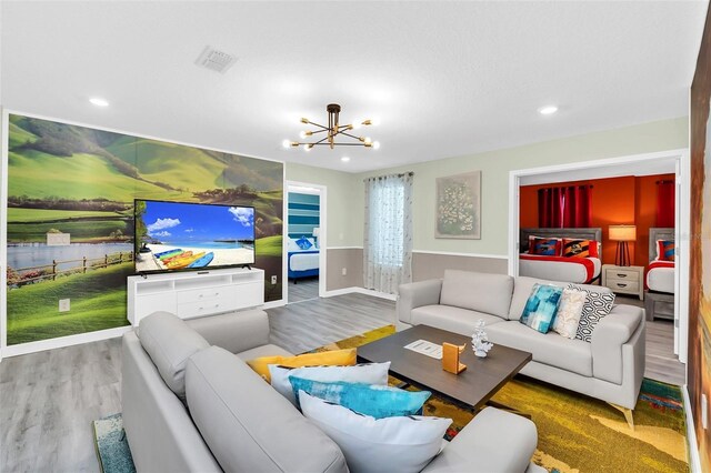 living room with wood-type flooring and an inviting chandelier