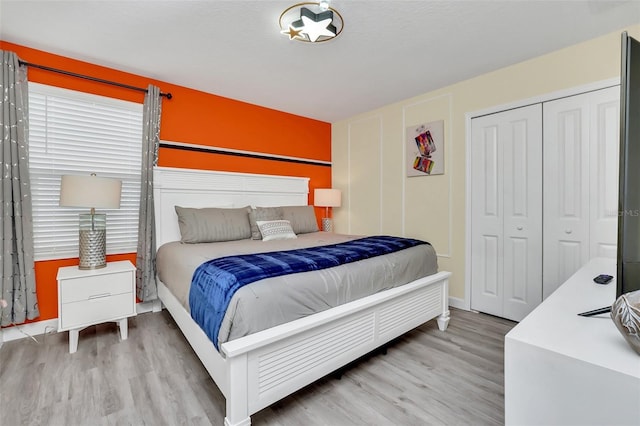 bedroom featuring a closet and light hardwood / wood-style flooring