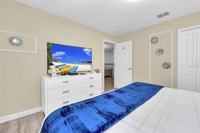 bedroom featuring light wood-type flooring and a closet