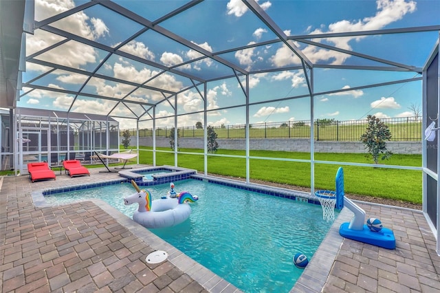 view of swimming pool with a lawn, a patio, glass enclosure, and an in ground hot tub