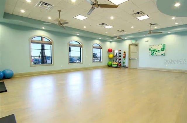 exercise area with ceiling fan and a drop ceiling