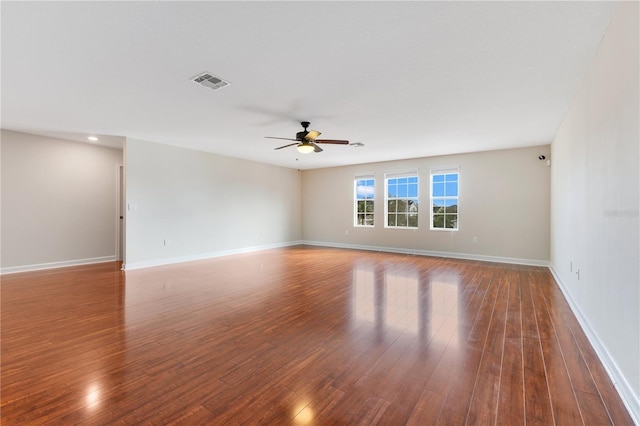 spare room with ceiling fan and dark wood-type flooring