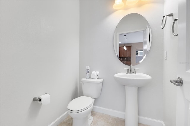 bathroom featuring tile patterned floors, toilet, and sink