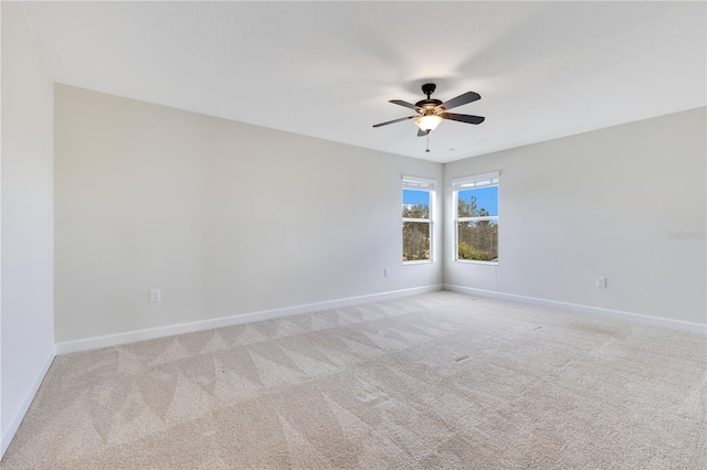 carpeted spare room featuring ceiling fan