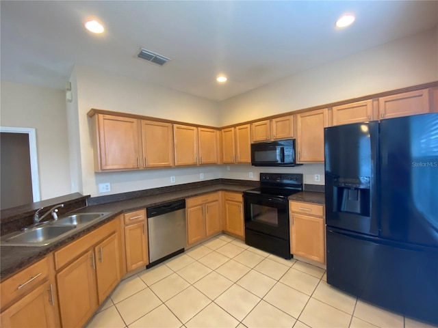 kitchen with black appliances, sink, and light tile patterned flooring