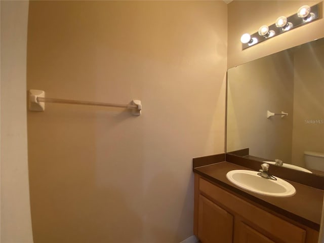 bathroom featuring toilet and vanity