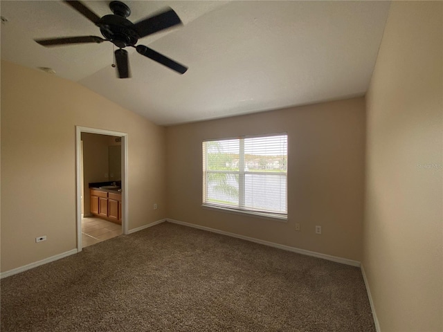 spare room with light carpet, ceiling fan, and lofted ceiling