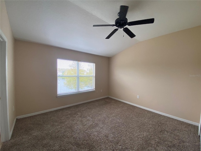 carpeted spare room with vaulted ceiling and ceiling fan