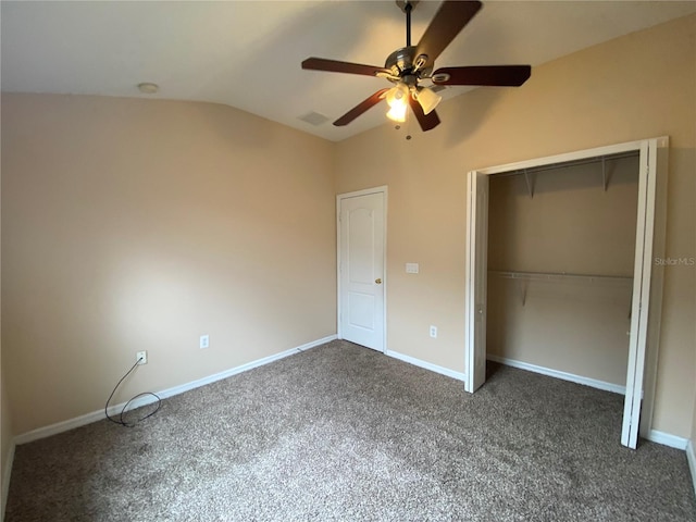 unfurnished bedroom featuring vaulted ceiling, ceiling fan, a closet, and dark carpet