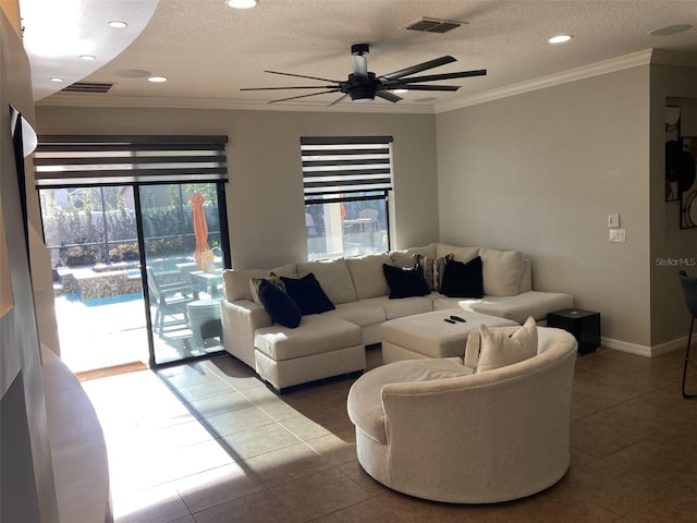 tiled living area featuring a textured ceiling, a ceiling fan, visible vents, and crown molding