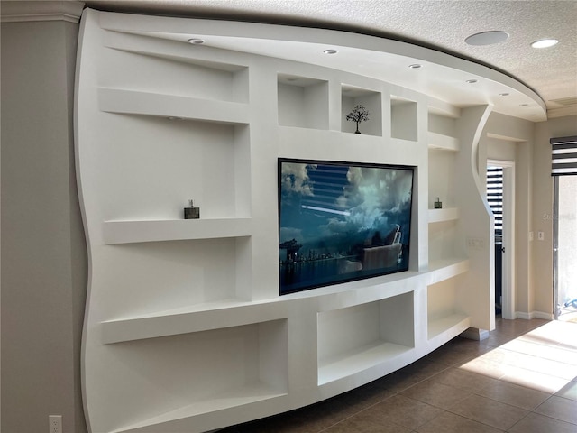 interior space featuring built in shelves, recessed lighting, and a textured ceiling