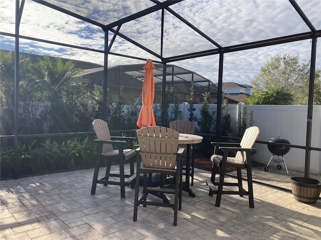 view of patio with a fenced backyard and a lanai