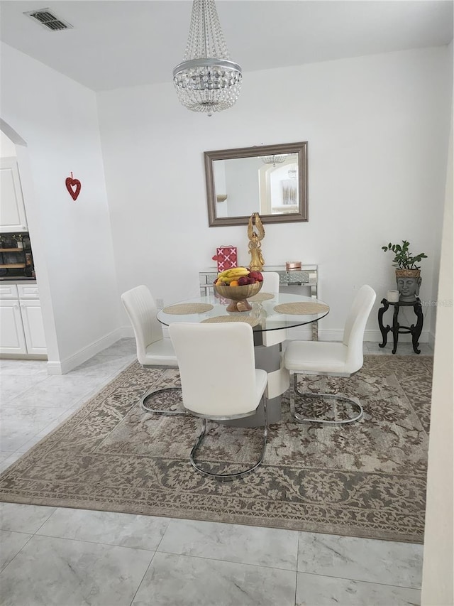 dining room with a notable chandelier