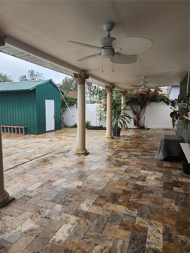 view of patio / terrace with ceiling fan and a shed