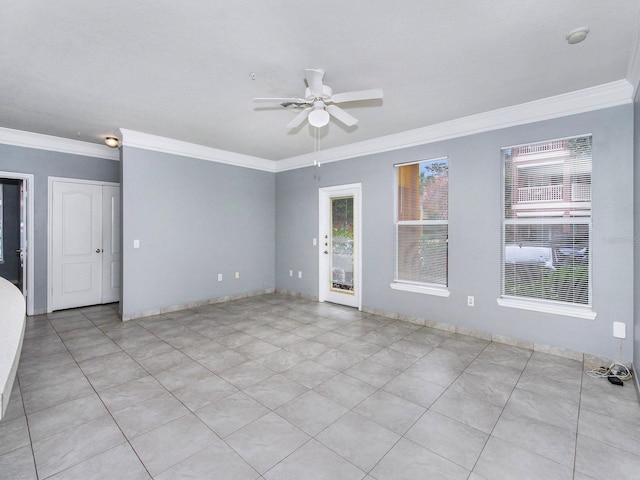 tiled spare room with ceiling fan and crown molding