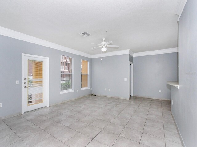 tiled spare room featuring ceiling fan and crown molding