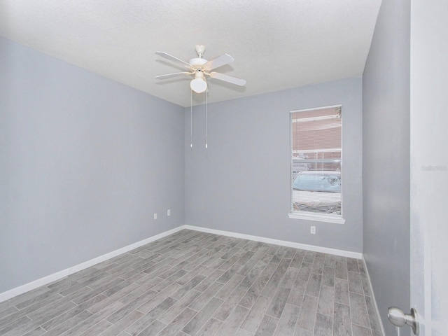 empty room featuring ceiling fan and light hardwood / wood-style floors