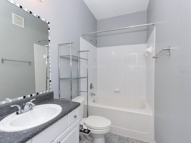 full bathroom with bathing tub / shower combination, vanity, hardwood / wood-style flooring, and toilet