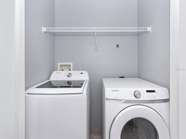 washroom with washing machine and clothes dryer