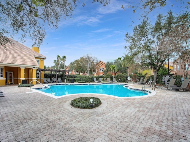 view of swimming pool featuring a pergola and a patio area